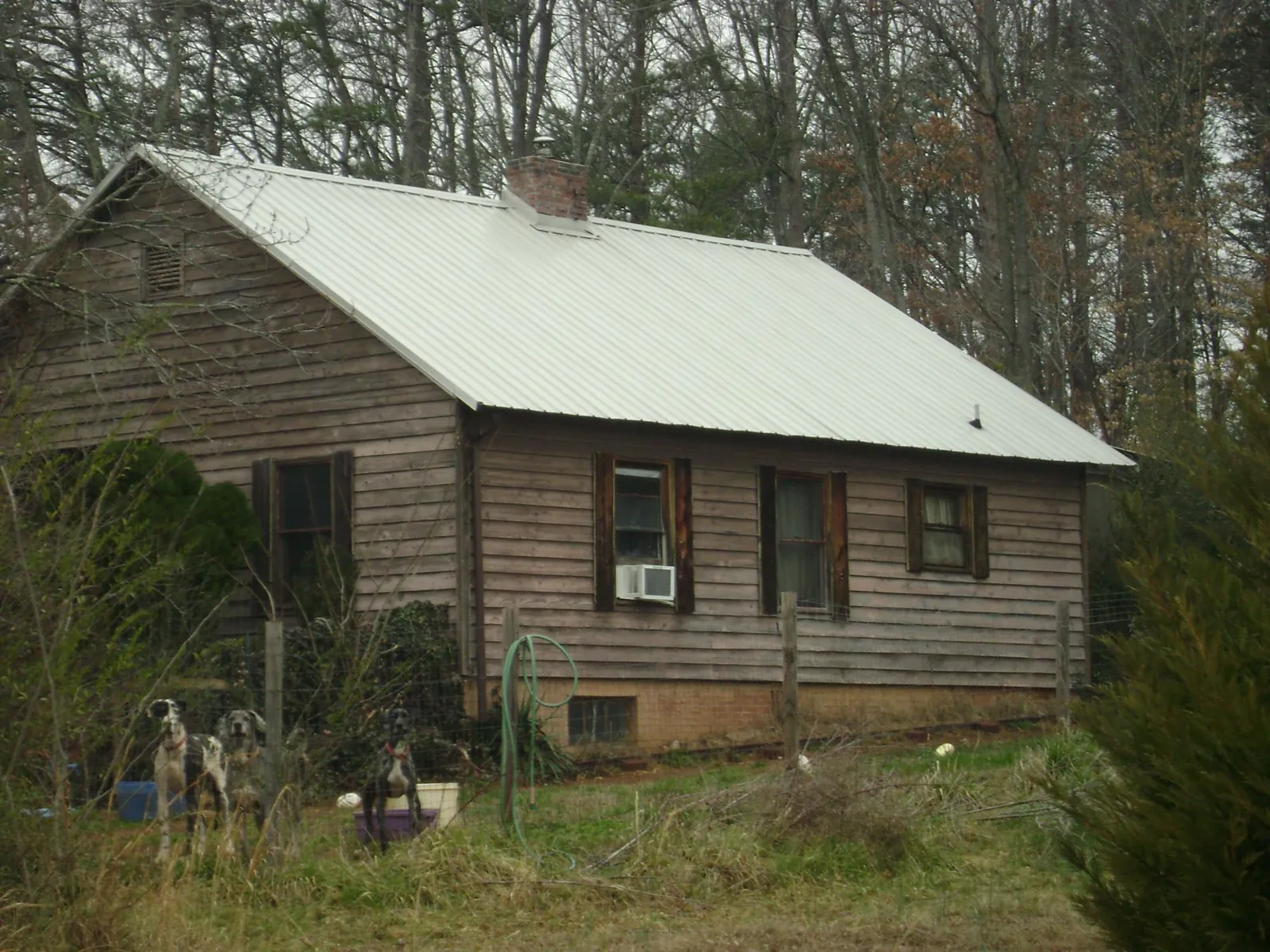 White metal roof on an old wood sided farmhouse, from a Metal Roof Installation job in Montgomery